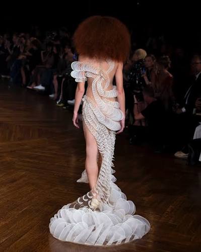 Sculptural white Iris van Herpen couture look photographed on the runway